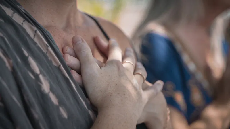 Sarah resting her hands over her heart