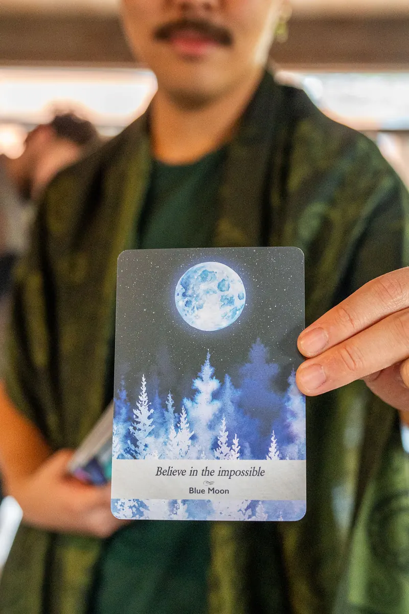 Hands holding oracle cards