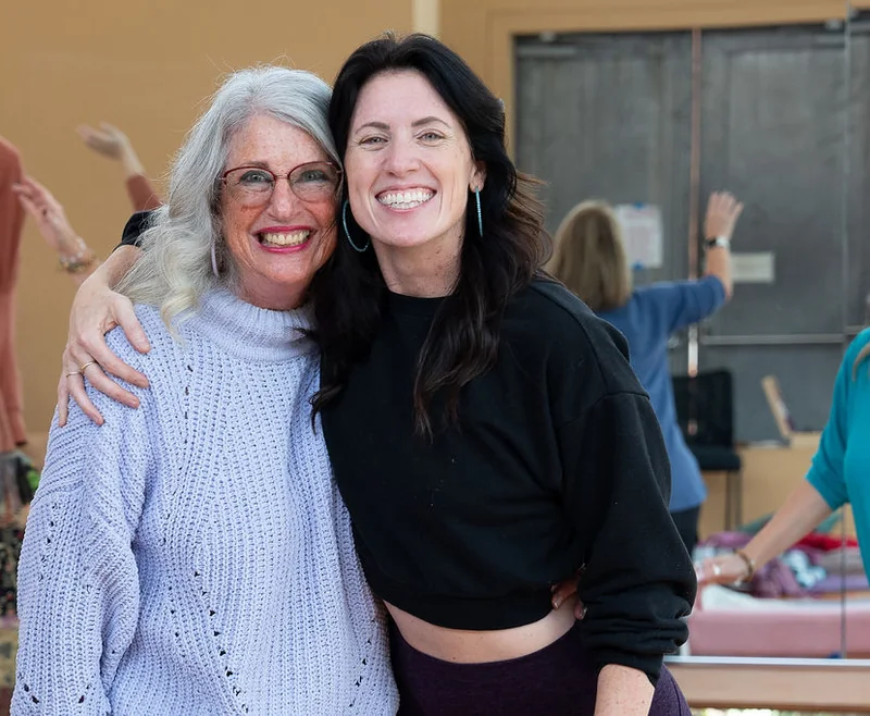 Sarah and her mom, Petey Silveira, hugging and smiling at last year’s retreat