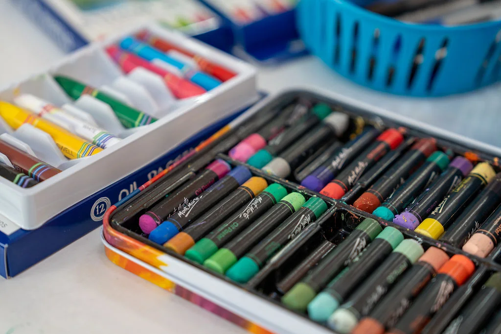 Trays of paints and oil pastels in the art studio
