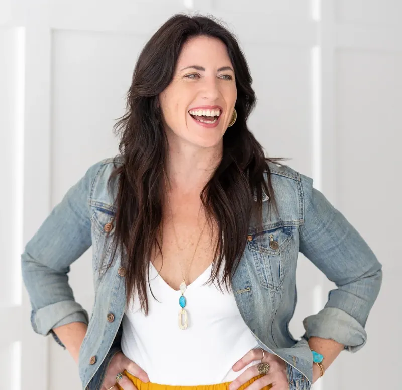 Sarah Burnett laughing in a denim jacket