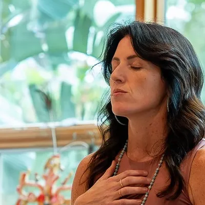 Sarah with her hand on her heart