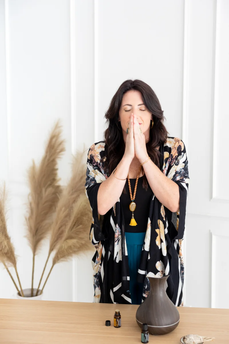 Sarah breathing in deeply with her hands together at her face